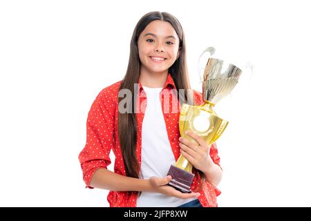 Teenage girl holding a trophy. Kid winner child won the competition, celebrating success and victory, achievement award. Portrait of happy smiling Stock Photo