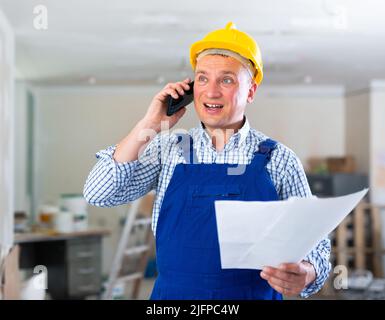 Construction worker having telephone conversation Stock Photo