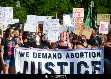 Various activist groups march over Brooklyn Bridge in New York City to demand justice for abortion, environment, black lives on July 4, 2022. Stock Photo