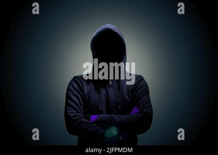 Hackers with a darkness of black background. Stock Photo