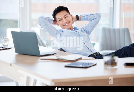 Let your work do the talking. Shot of a young businessman resting while working in a modern office. Stock Photo