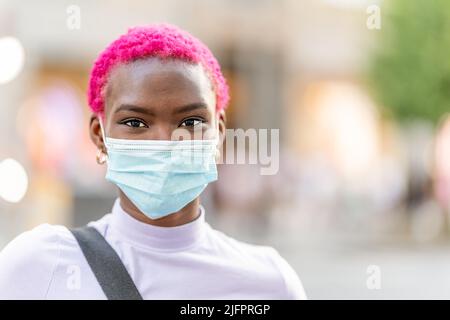 Young modern african woman wearing facial protective mask Stock Photo