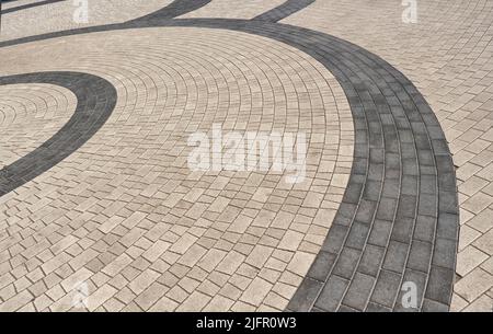Street gray striped pavement of polished paving stones. Stock Photo