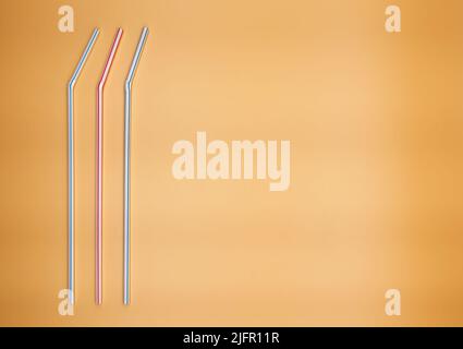 Colorful drinking straws isolated on orange background. Stock Photo