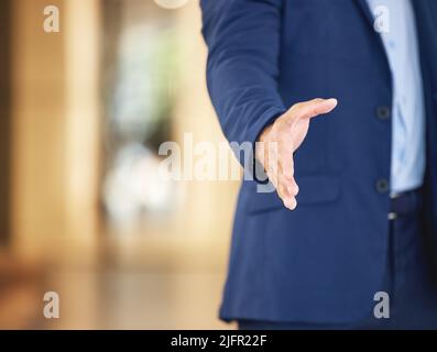 My offer to you still stands. Closeup shot of an unrecognisable businessman extending a handshake in an office. Stock Photo