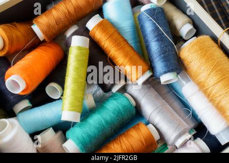 Premium Photo  Close-up on sewing thread spools