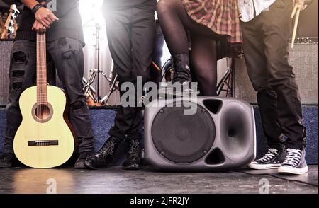 Ready to play. Cropped shot of an unrecognizable band standing on stage before their gig. Stock Photo