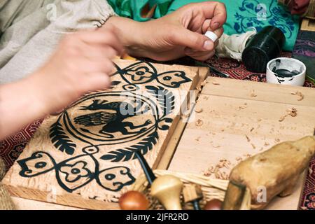 Wooden stamps for medieval ink printing on fabric and vintage clothing. Reconstruction of the events of the Middle Ages in Europe. Stock Photo