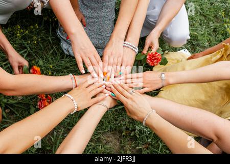 Group of people stacking hands together. Teamwork Stock Photo