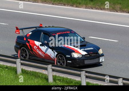 2004 black Motorsport Subaru Impreza Wrx 1994cc petrol saloon with rear spoiler, turbocharged, four-wheel-drive saloon; driving on the M6 Motorway, Manchester, UK Stock Photo