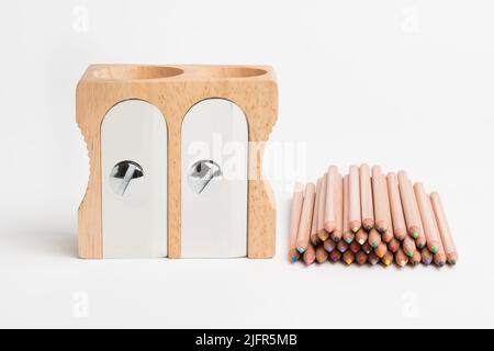 Keep it sharp, make your mark. Studio shot of a wooden sharpener and pencils. Stock Photo