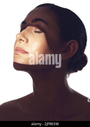silhouette of a young beautiful woman at dawn sitting on the ground and ...