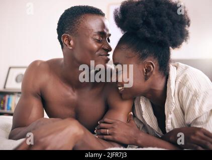 Can we stay in this moment forever. Shot of a young couple relaxing together at home. Stock Photo