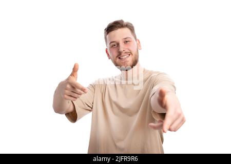 Smiling man pointing index fingers Stock Photo