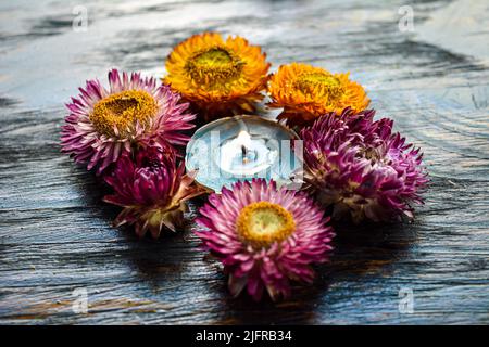 Burning candle on wooden background. Stock Photo