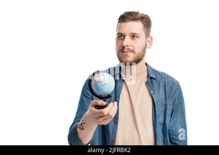 Thoughtful man holding globe Stock Photo