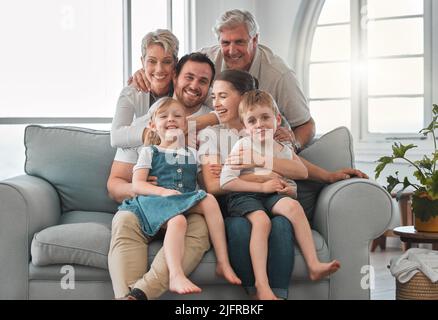 The memories we make with our family is everything. Shot of a happy family relaxing on the sofa at home. Stock Photo