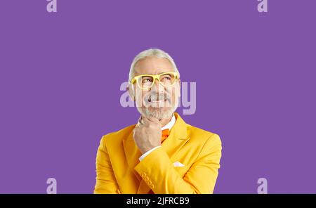 Dreamy positive mature man look up empty space, grey-haired male in contemplation Stock Photo