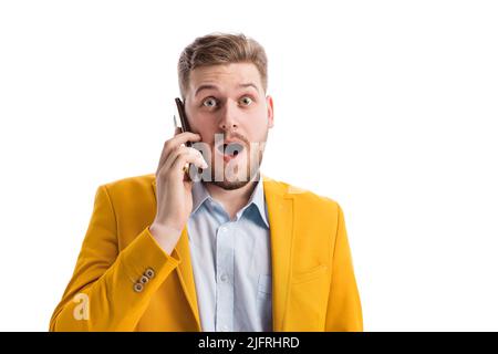 Surprised male talking on smartphone Stock Photo