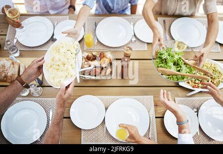 We want of everything on the table. Shot of a family enjoying a meal together. Stock Photo