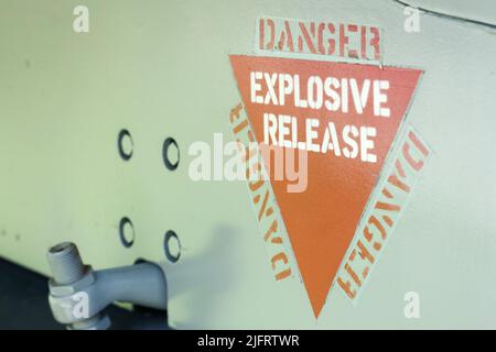 Danger Explosive Release, aircraft warning decal or sign on an old jet fighter airplane Stock Photo