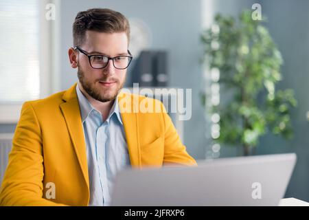 Positive businessman working online Stock Photo