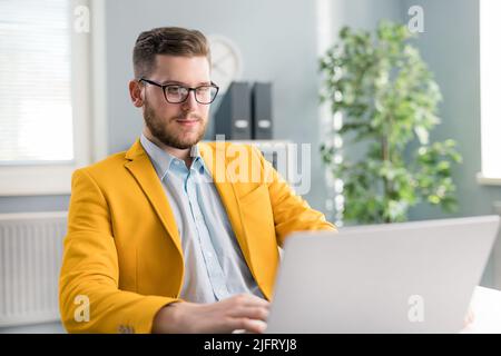 Man with laptop in office Stock Photo