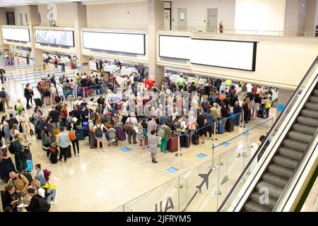 Luqa, Malta - October 22, 2021: People lining up to check-in counters at the Luqa airport in Malta. Stock Photo