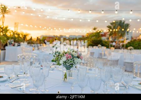 Banquet tables with empty glasses on street Stock Photo