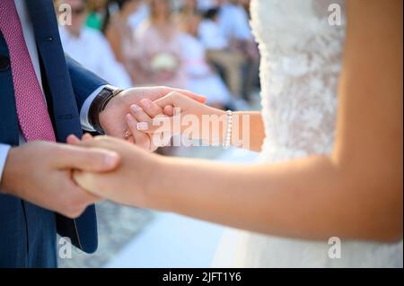 Anonymous newlyweds holding hands during wedding ceremony Stock Photo