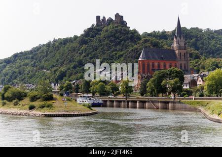 View of Gothic Liebfrauenkirche (Church of Our Lady) along the upper middle Rhine River in Oberwesel, Germany. Also called The Red Church. Stock Photo