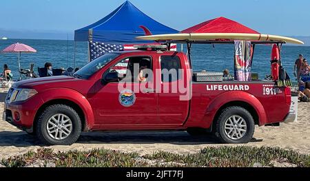 Santa Barbara, California, USA. 4th July, 2022. Red Lifeguard truck drives past an American flag on a picnic tent at East Beach, in Santa Barbara California, USA, on a sunny July 4th Holiday at the Pacific Ocean. (Credit Image: © Amy Katz/ZUMA Press Wire) Stock Photo