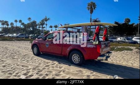 Santa Barbara, California, USA. 4th July, 2022. Red Lifeguard truck drives past an American flag on a picnic tent at East Beach, in Santa Barbara California, USA, on a sunny July 4th Holiday at the Pacific Ocean. (Credit Image: © Amy Katz/ZUMA Press Wire) Stock Photo