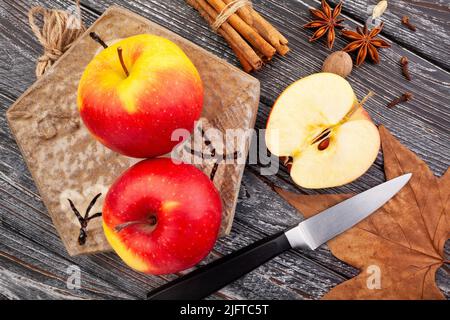 sliced colorful apples on wood background Stock Photo