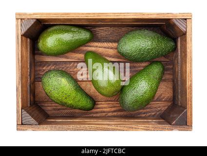 avocado in wooden box path isolated on white top view Stock Photo