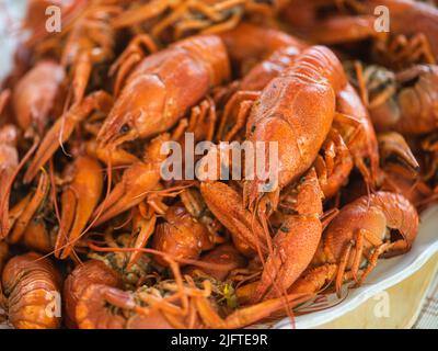 River crayfish are boiled in boiling water. Red freshly boiled crayfish. Narrow banner. Close-up, selective focus. Stock Photo