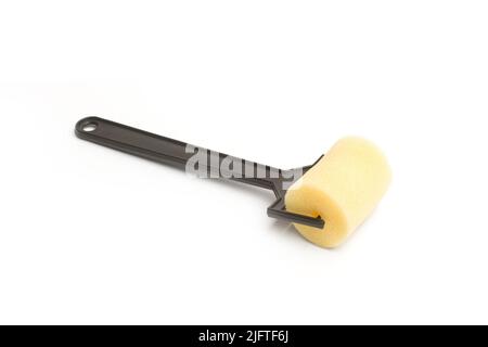 A small paint roller on a white background with copy space Stock Photo