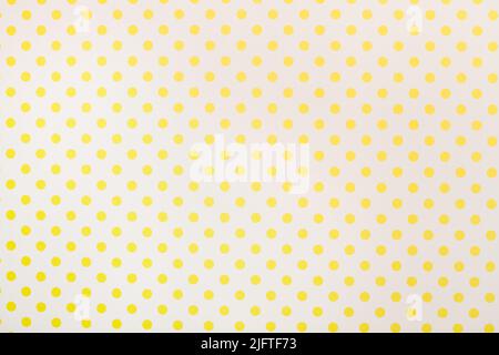 A gray paper background with yellow polka dots Stock Photo