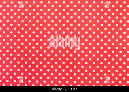 A red paper background with white polka dots Stock Photo