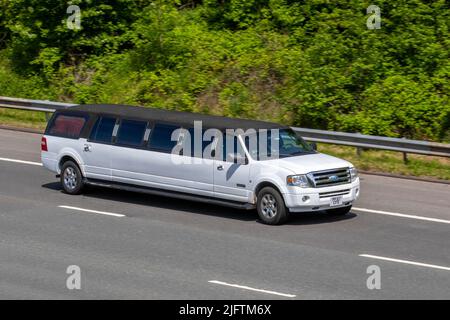 2008 white Ford Excursion Limousine, long stretched limousine Petrol 5400cc party outing hire vehicle; driving on the M6 Motorway, Manchester, UK Stock Photo