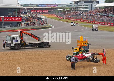 Recovery of Zhou Guanyu's Alfa Romeo British Grand Prix Formula 1 racing car, after crash at Farm Curve, Silverstone Circuit, England,UK,2022 Stock Photo