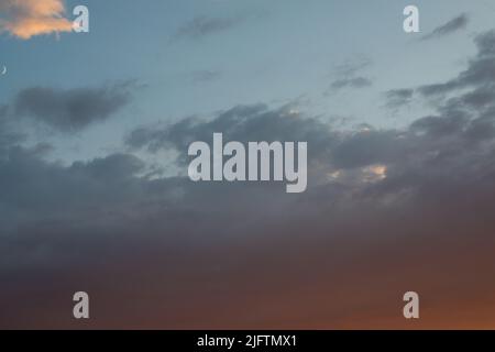 Dusk gloomy sky. Gray clouds with day light against blue sky. Dramatic dark clouds sky. Natural scenic view Stock Photo