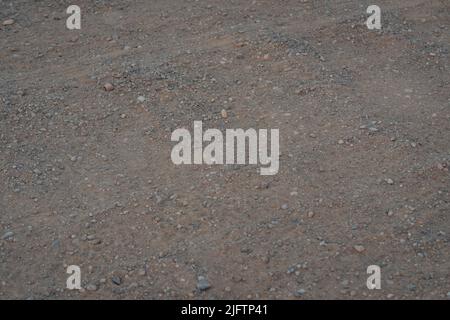 Detail of surface texture with small pebble rock on dirty ground. Stock Photo