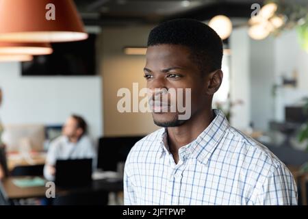 Thoughtful young african american businessman in creative office Stock Photo