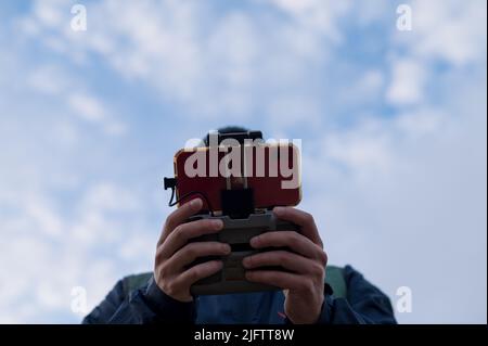 Person seen using drone remote control Stock Photo