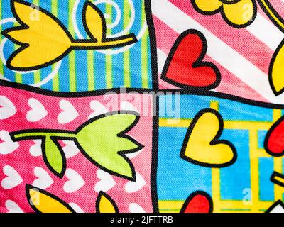 Original fabric background, with drawings of flowers and hearts. Horizontal view. Stock Photo