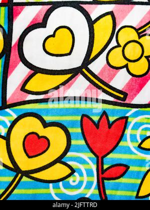 Original fabric background, with drawings of flowers and hearts. Vertical view. Stock Photo