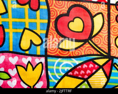 Original fabric background, with drawings of flowers and hearts. Horizontal view. Stock Photo