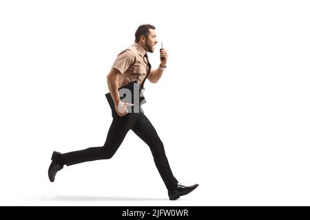 Full length profile shot of a security guard running and using a walkie talkie isolated on white background Stock Photo