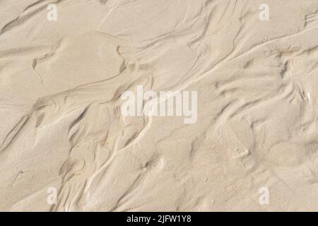 Above view of beach sand with wind swept patterns from gust winds with copy space. Closeup of detail and texture background with copyspace of erosion Stock Photo